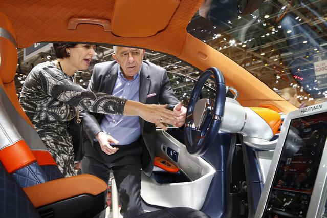 Rinspeed CEO Franck Rinderknecht shows the new Budii self-driving city car to Swiss Minister of Environment, Transport, Energy and Communications Doris Leuthard during the opening of the 85th International Motor Show in Geneva, 2015. (Photo by Arnd Wiegmann/Reuters)