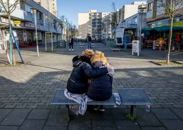 Two woman mourn near a kiosk in Hanau, Germany Friday, February 21, 2020 two days after a 43-year-old German man shot and killed several people at several locations in a Frankfurt suburb on Wednesday, Feb. 19, 2020. (Photo by Michael Probst/AP Photo)