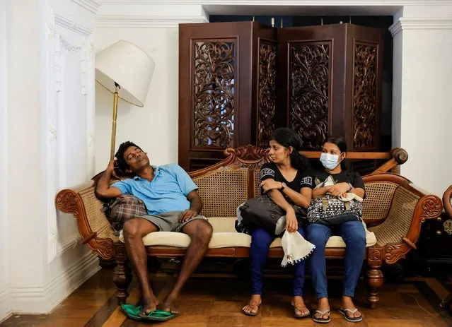 People sit on a couch inside the Sri Lankan Prime Minister's official residence, which was stormed by protesters over the weekend, amid the country's economic crisis, in Colombo, Sri Lanka on July 12, 2022. (Photo by Dinuka Liyanawatte/Reuters)