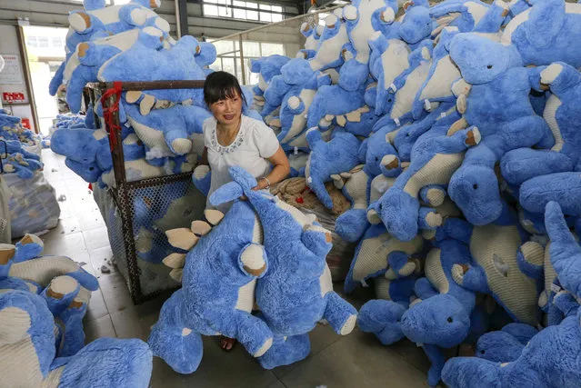 A worker makes stuffed toys for export to the US and Europe on July 12, 2016 in Lianyungang, China. (Photo by Imaginechina/Rex Features/Shutterstock)