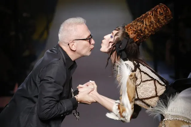 French designer Jean Paul Gaultier (L) appears with model Anna Cleveland at the end of his Haute Couture Fall Winter 2015/2016 fashion show in Paris, France, July 8, 2015. (Photo by Stephane Mahe/Reuters)