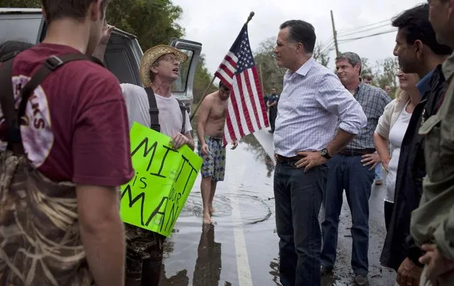 Republican presidential candidate Mitt Romney, accompanied by Sen. David Vitter, R-La., talks with local residents Aug. 31 during a tour of areas flooded by Hurricane Isaac in Jean Lafitte, La. (Photo by Evan Vucci/AP)