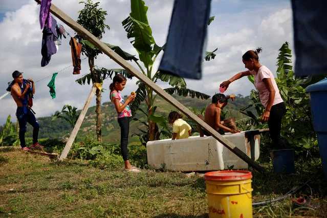 Lisibeht Martinez (R), 30, who was sterilized one year ago, plays with her children in a bathtub in the backyard of their house in Los Teques, Venezuela July 19, 2016. (Photo by Carlos Garcia Rawlins/Reuters)