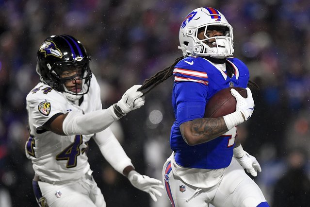 Baltimore Ravens cornerback Marlon Humphrey (44) grabs Buffalo Bills running back James Cook (4) as Cook carries the ball during the first quarter of an NFL divisional playoff football game, Sunday, January 19, 2025, in Orchard Park, N.Y. (Photo by Adrian Kraus/AP Photo)