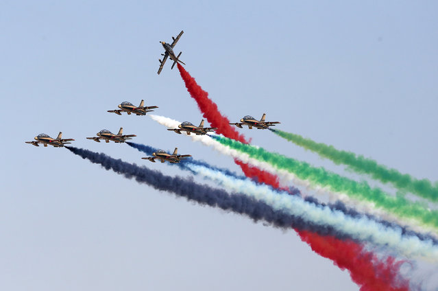 Aerobatic aircrafts emit coloured smoke trails as they perform during an airshow at the Abu Dhabi Air Expo, February 25, 2014. (Photo by Reuters/Stringer)