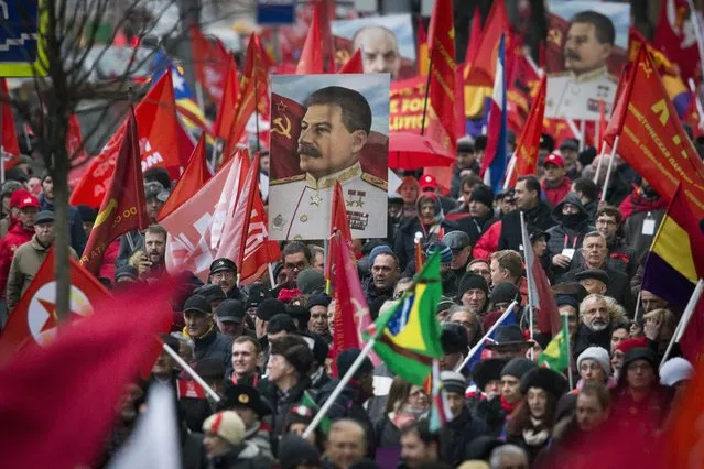 Communist party supporters carry portraits of Soviet founder Vladimir Lenin, rear centre, and Soviet dictator Josef Stalin during a demonstration marking the 100th anniversary of the 1917 Bolshevik revolution in Moscow, Russia, Tuesday, November 7, 2017. (Photo by Alexander Zemlianichenko/AP Photo)