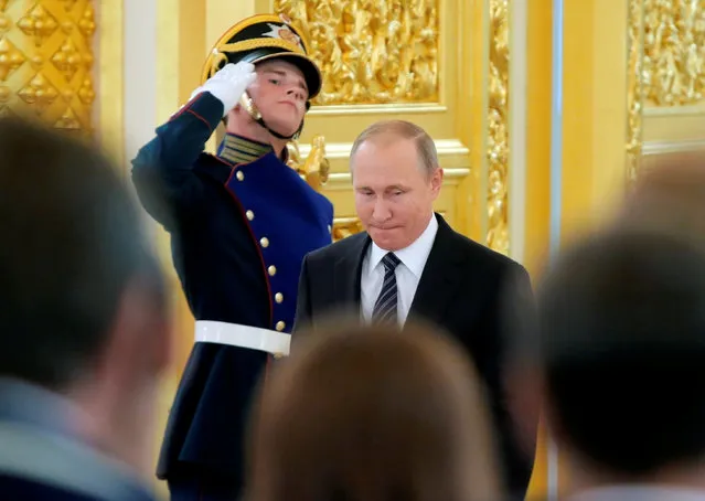 Russian President Vladimir Putin enters a hall during an awarding ceremony for Russian Olympic medallists returning home from the 2016 Rio Olympics, at the Kremlin in Moscow, Russia August 25, 2016. (Photo by Maxim Shemetov/Reuters)