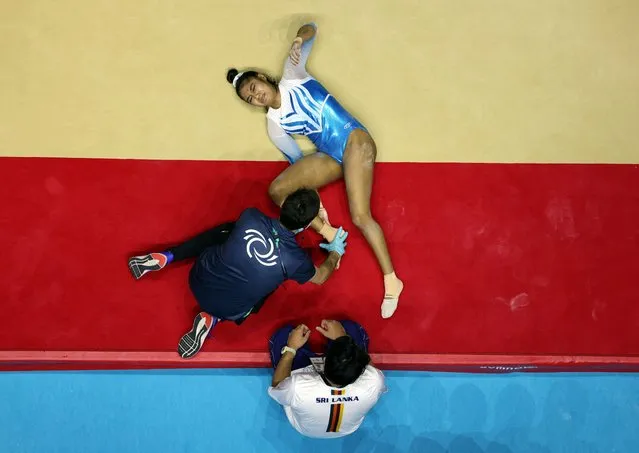 Sri Lanka's Milka Gehani receives medical attention after sustaining an injury at the Gymnastics World Championships in Liverpool, Britain at M&S Bank Arena on October 30, 2022. (Photo by Molly Darlington/Reuters)