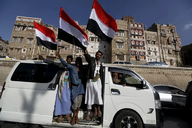 Houthi followers wave Yemen's national flag as they ride a van to a ceremony marking the first anniversary of their movement's takeover of the capital Sanaa September 21, 2015. (Photo by Khaled Abdullah/Reuters)