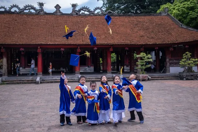 Pupils have their kindergarten graduation photo taken at Temple of Literature, a popular destination amongst both locals and tourists, on May 31, 2020 in Hanoi, Vietnam. Though some restrictions remain in place, Vietnam has lifted the ban on domestic travel, certain entertainment facilities and non-essential businesses to revive its economy. As of May 31, Vietnam has confirmed 328 cases of coronavirus disease (COVID-19 ) with no deaths in the country, 279 fully recovered and no new case caused by community transmission for 44 days. (Photo by Linh Pham/Getty Images)