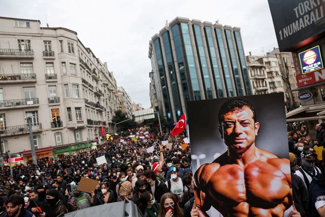 A person carries an image depicting Istanbul Mayor Ekrem Imamoglu, as people take part in a protest against the arrest of Imamoglu as part of a corruption investigation, in Istanbul, Turkey, on March 25, 2025. (Photo by Umit Bektas/Reuters)