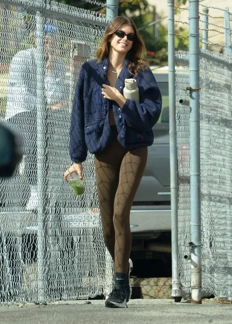 Kaia Gerber is pictured heading to the gym in Los Angeles on November 8, 2022. The 21 year old supermodel wore a blue fleece, crop top, brown Gymshark leggings, and Nike trainers. (Photo by The Image Direct)