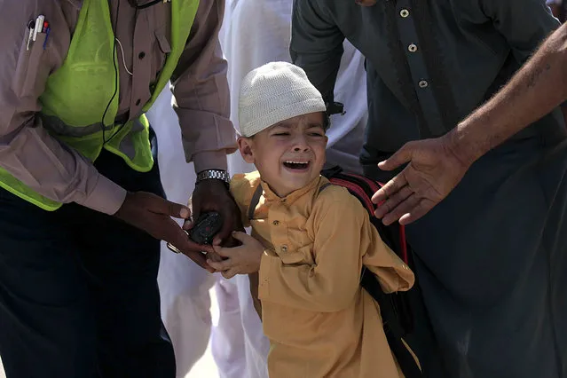 A school boy cries following a bomb blast targeting a Christian colony in the Khyber Pakhtunkhwa provincial capital of Peshawar, Pakistan, 02 September 2016. According to media reports, four suicide bombers were shot dead by security forces after they targeted a Christian neighborhood near Peshawar, one person was killed in this incident. In another incident a suicide bomber has targeted a court in Mardan, where 11 people were killed and 30 other were wounded. (Photo by Bilawal Arbab/EPA)