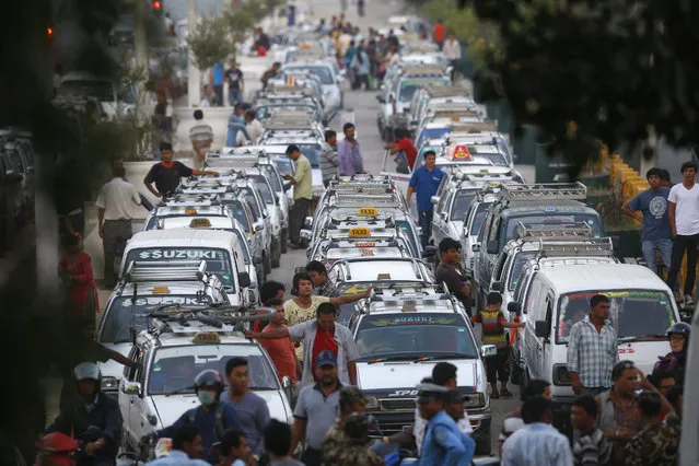 A line of taxis as drivers wait for fuel at a petrol station in Kathmandu, Nepal, 01 October 2015. The Nepalese are facing an acute crisis of petroleum products and other essential commodities after neighboring India stopped supplies. The Nepalese government has stopped providing fuel to private number plate vehicles across the country due to the fuel shortage. (Photo by Narendra Shrestha/EPA)