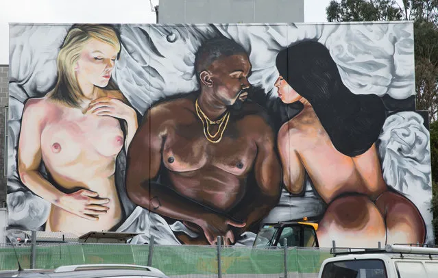 Melbourne street artist LushSux has painted a wall in Melbourne's trendy suburb of Richmond, depicting the controversial scene from Kanye West's music video for “Famous” with Kanye, Kim Kardashian and Taylor Swift in bed together, 2016. The large scale street art shows a naked Taylor Swift lying next to a naked Kanye West. Kim Kardashian is also naked and is lying on the other side of Kanye West. (Photo by Splash News and Pictures)