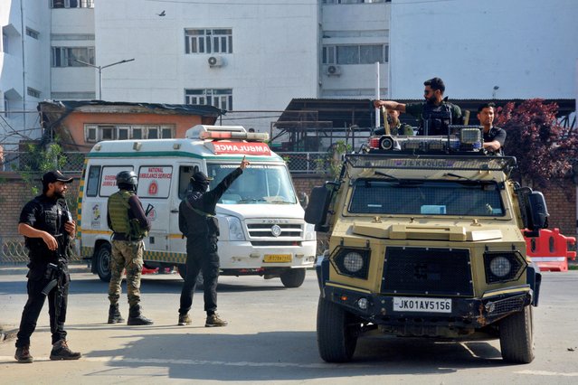 Indian security forces personnel escort an ambulance carrying the bodies of tourists who were killed in a suspected militant attack near Pahalgam, outside the police control room in Srinagar on April 23, 2025. (Photo by Reuters/Stringer)