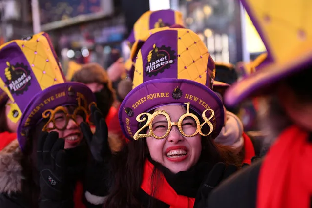 Revelers brace in freezing cold temperatures in Times Square in Manhattan, New York on January 1, 2018. (Photo by Darren Ornitz/Reuters)