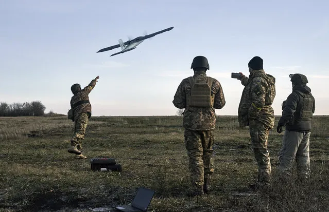 Ukrainian soldiers launch a drone at Russian positions near Bakhmut, Donetsk region, Ukraine, Thursday, December 15, 2022. (Photo by LIBKOS/AP Photo)