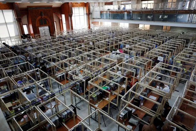 Jewish seminary students study at desks fitted with plastic sheets to protect them from the spread of the coronavirus disease (COVID-19) in Sderot, Israel on August 26, 2020. (Photo by Ronen Zvulun/Reuters)