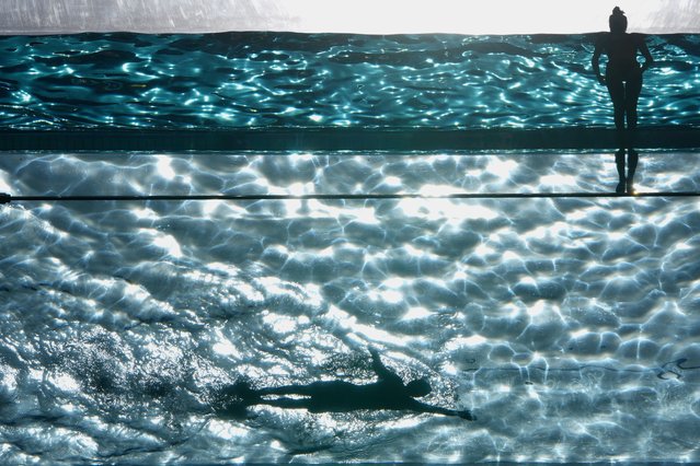 People swim in the Sky Pool on a sunny day in London, Thursday, May 1, 2025. (Photo by Kin Cheung/AP Photo)