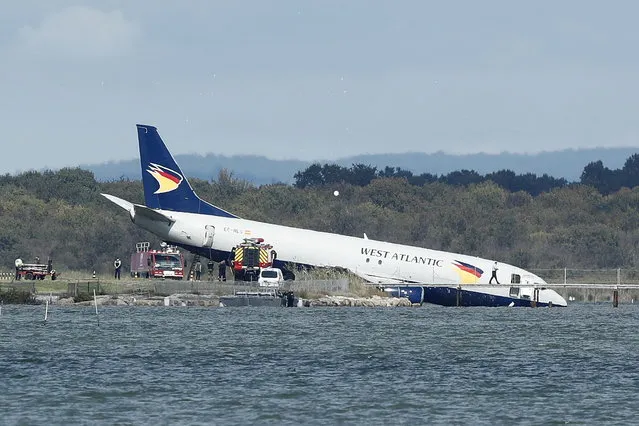 Rescue services and police act near near Boeing 737-436 (SF) cargo plane by the West Atlantic operator, that crashed after landing and came to a halt with its nose in lake near the airport of Montpellier, Southern France, 24 September 2022. There were no immediate information about the cause of the crash, that is under investigation, while the three crew members were reported unharmed. The airport of Montpellier was closed for an indefinite time, the Prefect of Herault announced in a press ststement. (Photo by Guillaume Horcajuelo/EPA/EFE)