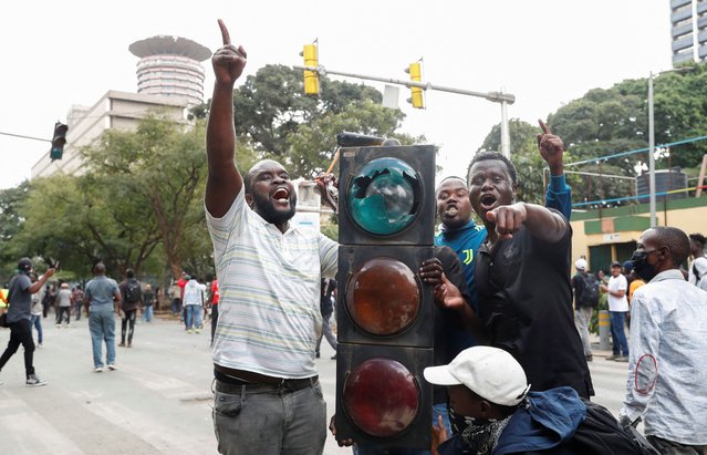 Protestors hold a vandalised traffic light as they chant slogans during a demonstration against the death of a blogger in police custody last week, in downtown Nairobi, Kenya on June 12, 2025. (Photo by Thomas Mukoya/Reuters)