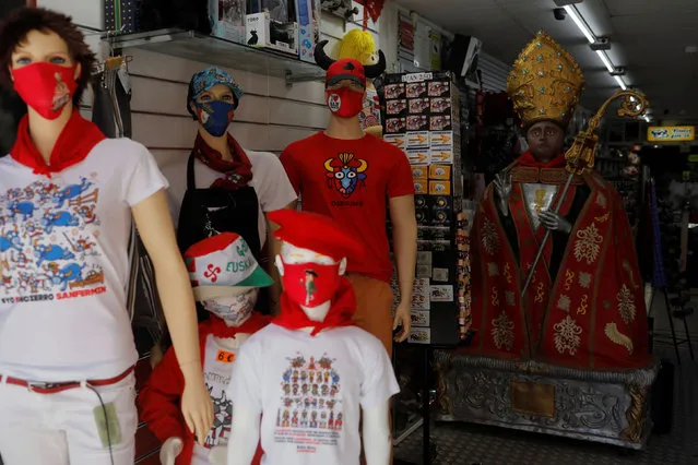 Mannequins and a figure of Saint Fermin are seen in “La curva de Estafeta” souvenir shop, along the 875-meter course of the running of the bulls from a corral to the bullring, at the curve of Estafeta street during the San Fermin festival which was cancelled due to the coronavirus disease (COVID-19) outbreak, in Pamplona, Spain on July 7, 2020. (Photo by Jon Nazca/Reuters)