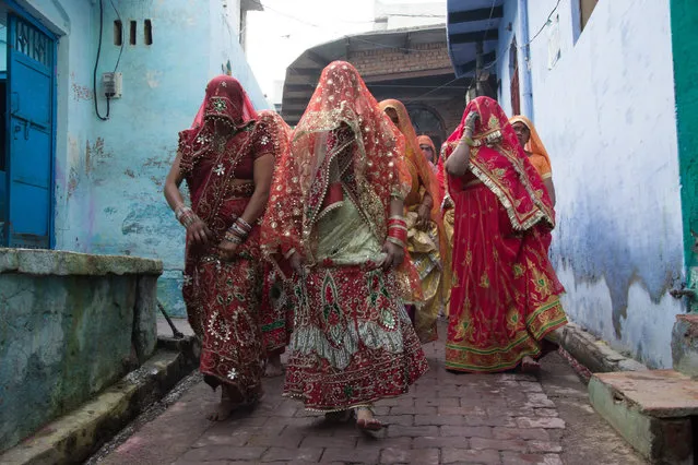 Indian women beat men with stick (Lathi) during celebration of Lathmar Holi in Nandgaon village of Mathura district in Uttar Pradesh, India on February 25, 2018. (Photo by Javed Sultan/Anadolu Agency/Getty Images)