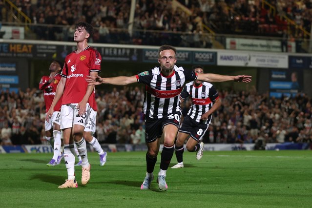 Charles Vernam of Grimsby Town celebrates scoring his team's first goal during the Carabao Cup Second Round match between Grimsby Town and Manchester United at Blundell Park on August 27, 2025 in Grimsby, England. (Photo by George Wood/Getty Images)
