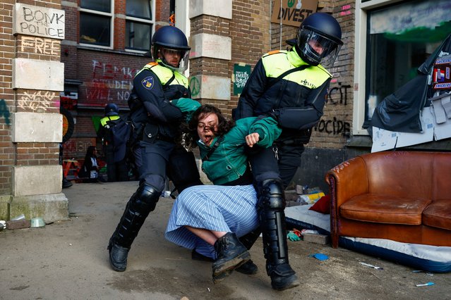 Police officers remove a pro-Palestinian protester outside the University of Amsterdam during a protest against the ongoing conflict between Israel and the Palestinian Islamist group Hamas in Gaza, in Amsterdam, Netherlands, on May 8 2024. (Photo by Piroschka van de Wouw/Reuters)