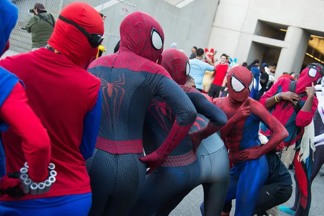 Attendees dressed as Spider-Man pose outside New York Comic Con at the Javits Center on Friday, October 7, 2016, in New York. (Photo by Charles Sykes/Invision/AP Photo)