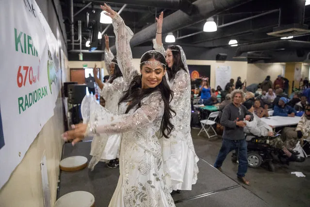 Traditional musicians and dancers entertained as Iranian-American volunteers cook and serve food for homeless and near-homeless people at Midnight Mission shelter on Skid Row to celebrate Nowruz, Iranian New Year in Los Angeles, California, U.S. March 16, 2018. (Photo by Monica Almeida/Reuters)