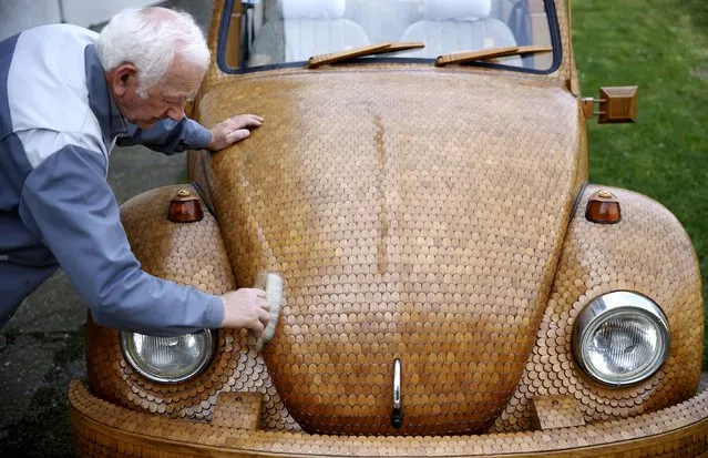 Bosnian pensioner Momir Bojic cleans his wooden Volkswagen Beetle car in front of his home in Celinac near Banja Luka, in this April 2, 2014 file picture. Germany is to retest all Volkswagen car models to gauge their genuine emissions levels after new revelations from the carmaker six weeks into its biggest-ever corporate scandal pushed the government to act. (Photo by Dado Ruvic/Reuters)