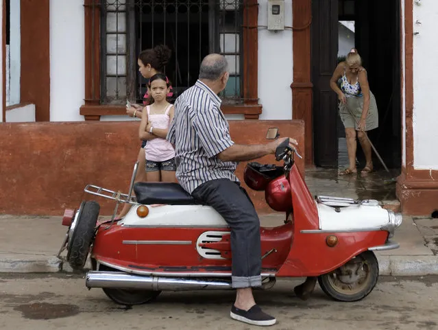A man sits on his Czech-made 1962 model CZ 502 scooter in the village of Artemisa, west of Havana, February 6, 2010. (Photo by Desmond Boylan/Reuters)