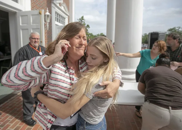 Judge Sarah Ritterhoff Williams embraces family friend student Attie French after finding her in the crowd at First Baptist Church while looking for her own daughter following a shooting at Forest High School, Friday April 20, 2018 in Ocala, Fla. (Photo by Alan Youngblood/Star-Banner via AP Photo)