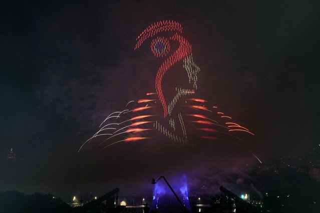 Lights illuminate the sky and shape the face of Marianne, the national personification of the French Republic, during a drone, lights and fireworks show in front of the Eiffel Tower as part of the annual Bastille Day celebrations and ahead of the Paris 2024 Olympic Games in Paris, on July 14, 2024. (Photo by Dimitar Dilkoff/AFP Photo)