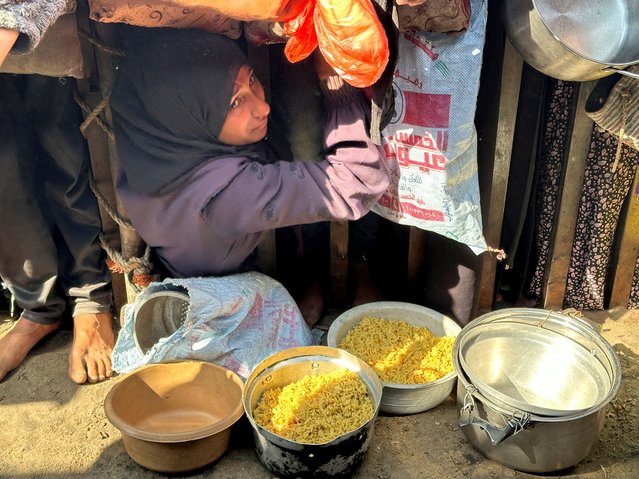 Palestinians gather to receive food from a charity kitchen amid a ceasefire between Israel and Hamas, in Khan Younis in the southern Gaza Strip, on November 5, 2025. (Photo by Haseeb Alwazeer/Reuters)