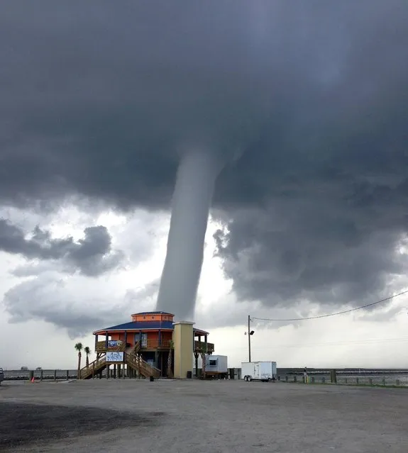 This photo provided by “Buggie” Vegas, owner of Bridge Side Cabins and Marina in Grand Isle, La., shows a waterspout Wednesday, June 19, 2013, on Grand Isle, La.  The waterspout did little damage, according to the National Weather Service. (Photo by Buggie Vegas/AP Photo)