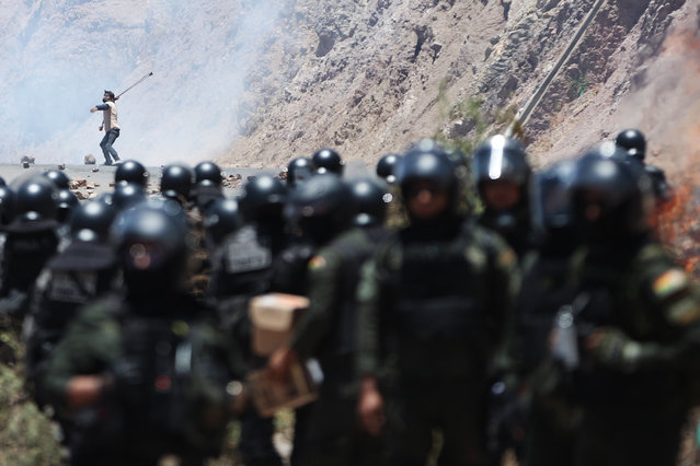A man confronts members of the Bolivian Military Police during a blockade by supporters of former Bolivian President Evo Morales (2006-2019) in Parotani, Bolivia, 01 November 2024. A large contingent of Bolivian police and military are clearing the roads that have been occupied by Morales' followers for the past 19 days, as they protest in defense of their leader in light of a possible arrest warrant against him for a case of human trafficking and statutory rape. (Photo by Luis Gandarillas/EPA/EFE)