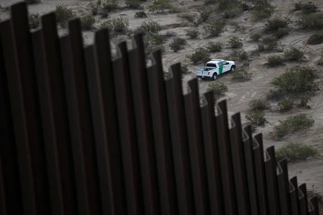 A U.S. police patrol vehicle is seen behind a section of the wall separating Mexico and the United States, on the outskirts of Ciudad Juarez, Mexico, November 12, 2016. (Photo by Jose Luis Gonzalez/Reuters)