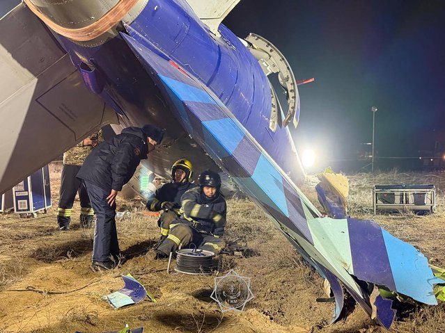 In this handout picture released by Kazakhstan's emergency situations ministry on December 26, 2024, emergency specialists work at the crash site of an Azerbaijan Airlines passenger jet near the western Kazakh city of Aktau. (Photo by Handout/Kazakhstan's emergency situations ministry via AFP Photo)