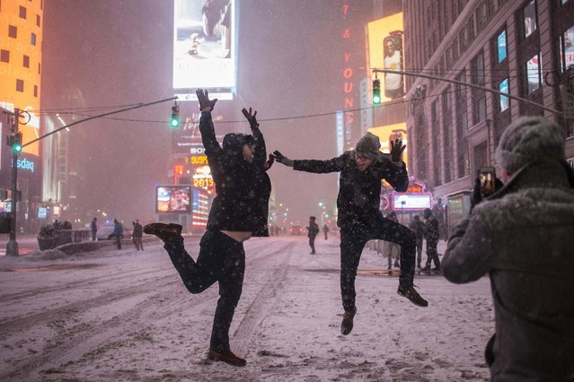 Men play in the snow along 7th Ave during a storm in Times Square, New York early morning January 27, 2015. (Photo by Adrees Latif/Reuters)