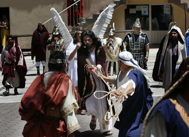 Brando Neri Luna plays the role of Jesus Christ during the Passion Play of Iztapalapa, outside the Cathedral, on the outskirts of Mexico City, Friday, April 2, 2021, amid the new coronavirus pandemic. To help prevent the spread of the COVID-19, Latin America's most famous re-enactment of the crucifixion of Christ was closed to the public and transmitted live so people could watch at home, for a second consecutive year. (Photo by Marco Ugarte/AP Photo)