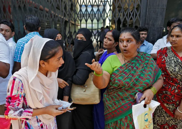 People argue with each other as they wait for their turn to exchange or deposit their old high denomination banknotes outside a bank in Mumbai, India, November 24, 2016. (Photo by Danish Siddiqui/Reuters)