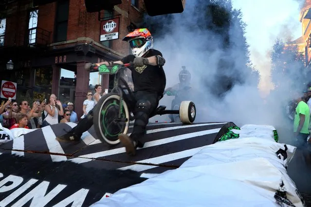 Riders battle ramps, smoke and each other at the Danger Wheel downhill race presented by Huffy Green Machine on Saturday, July 29, 2023 in Cincinnati. The annual “downhill Big Wheel race for adults” benefits the beautification of the Pendleton neighborhood in Cincinnati and served as the national launch for the new Huffy Green Machine. (Photo by Tom Uhlman/AP Images for Huffy Bicycles)