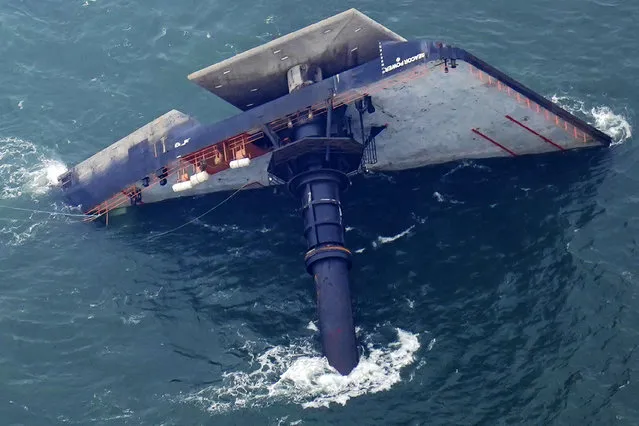 The capsized lift boat Seacor Power is seen seven miles off the coast of Louisiana in the Gulf of Mexico Sunday, April 18, 2021. The vessel capsized during a storm on Tuesday. (Photo by Gerald Herbert/AP Photo)