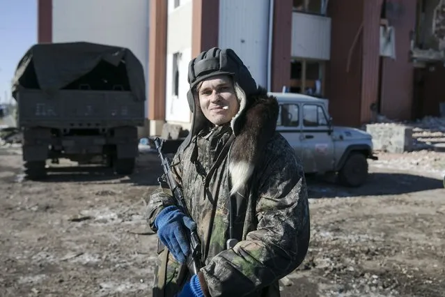 A fighter with separatist self-proclaimed Donetsk People's Republic poses with his rifle in the village of Nikishine, south east of Debaltseve  February 17, 2015. (Photo by Baz Ratner/Reuters)