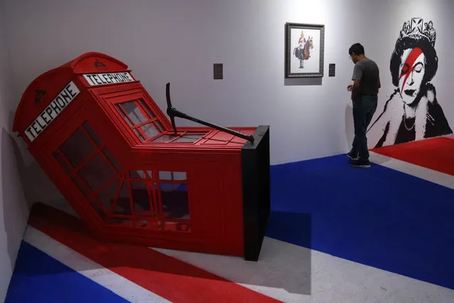 Visitors observe works by the British artist Banksy during the exhibition “The Art of Banksy: without limits” in the city of Guadalajara, Mexico, 30 August 2023. More than a hundred works by the British artist Banksy make up the exhibition “The Art of Banksy: Without Limits”, which opened its doors to the public on 30 August in the city of Guadalajara, capital of the state of Jalisco. (Photo by rancisco Guasco/EPA)