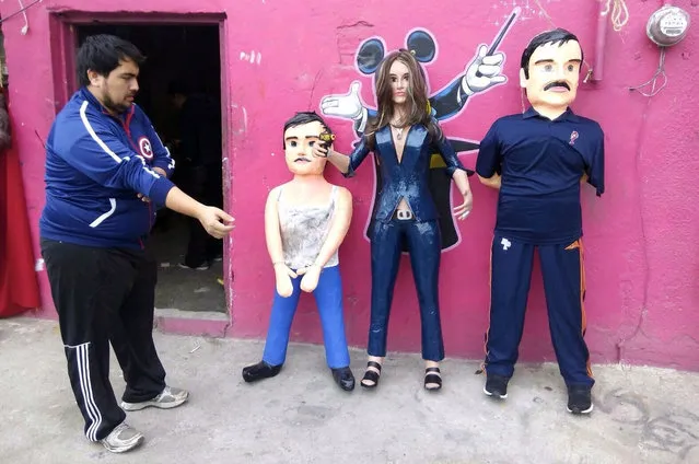 Pinatas depicting the Mexican actress Kate del Castillo and the drug lord Joaquin “El Chapo” Guzman are displayed outside a workshop in Reynosa, in Tamaulipas state, Mexico, January 13, 2016. (Photo by Xinhua/Barcroft Media)