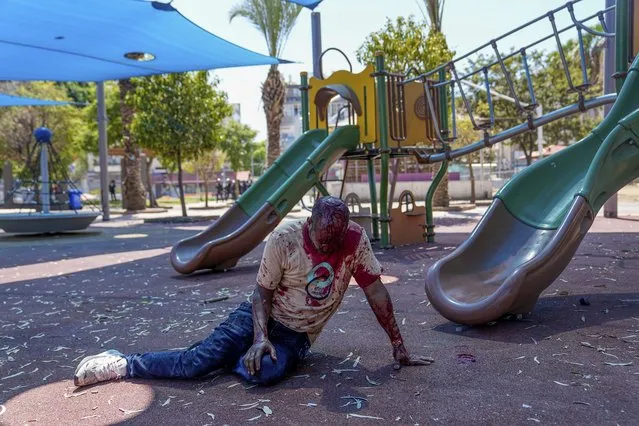A supporter of the Eritrean government lies injured and covered in blood after he was hurt by an Anti-Eritrean government activist, during a protest against an event organized by the Eritrea Embassy in Tel Aviv, Israel, Saturday, September 2, 2023. Hundreds of Eritrean asylum seekers smashed shop windows and police cars in Tel Aviv on Saturday and clashed with police during a protest against an event organized by the Eritrea Embassy. The Israeli police said 27 officers were injured in the clashes, and at least three protesters were shot when police opened fire with live rounds when they felt “real danger to their lives”. (Photo by Ohad Zwigenberg/AP Photo)